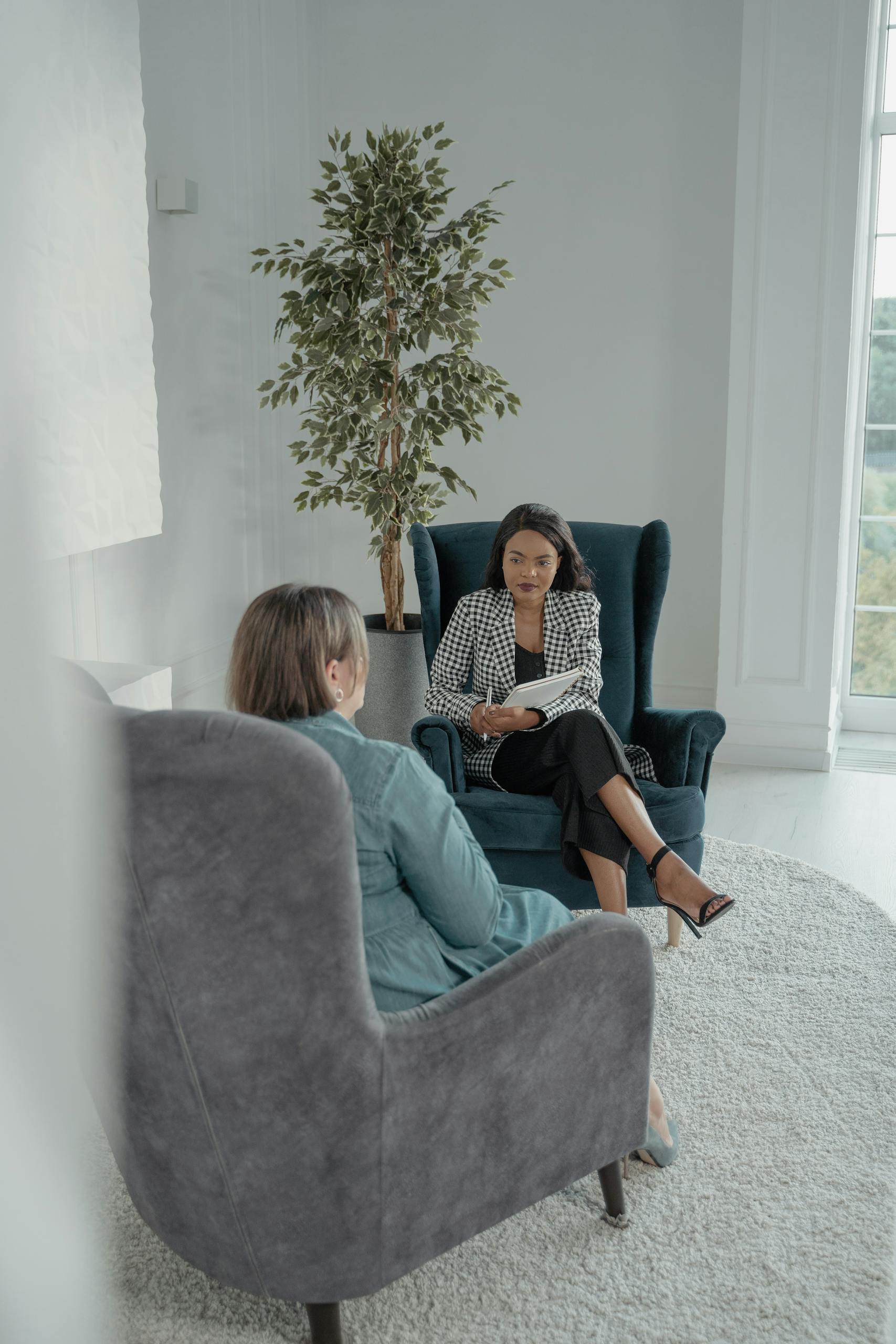 Two professional women having a focused business conversation indoors.